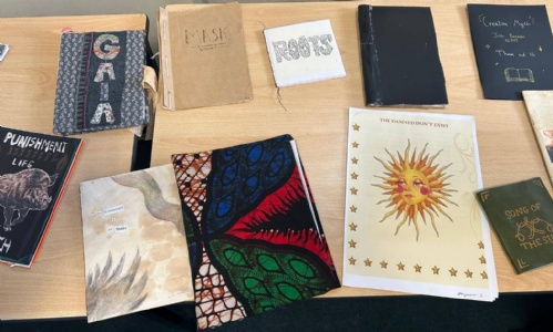 Covers of different poems on a table